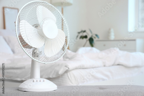 Electric fan on soft bench ...