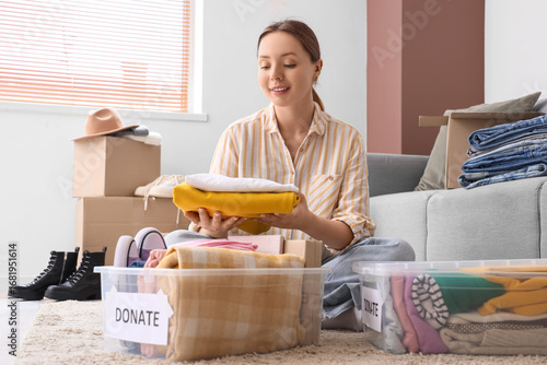 Young woman packing clothes...