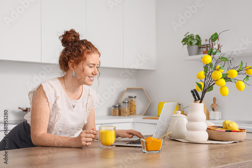 Young redhead woman with tu...