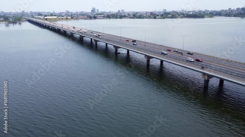 Wallpaper Mural Aerial View of a Long Bridge Spanning a Body of Water with City Skyline. ivory coast Torontodigital.ca