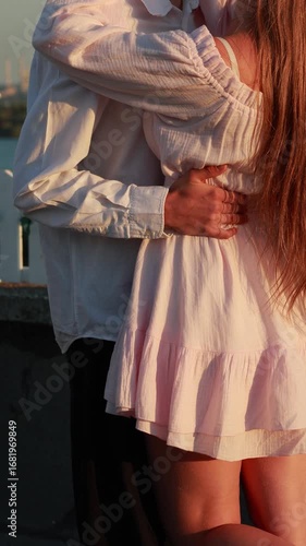 Romantic couple embracing outdoors in warm sunlight in vertical video