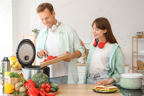 Young couple cooking with m...