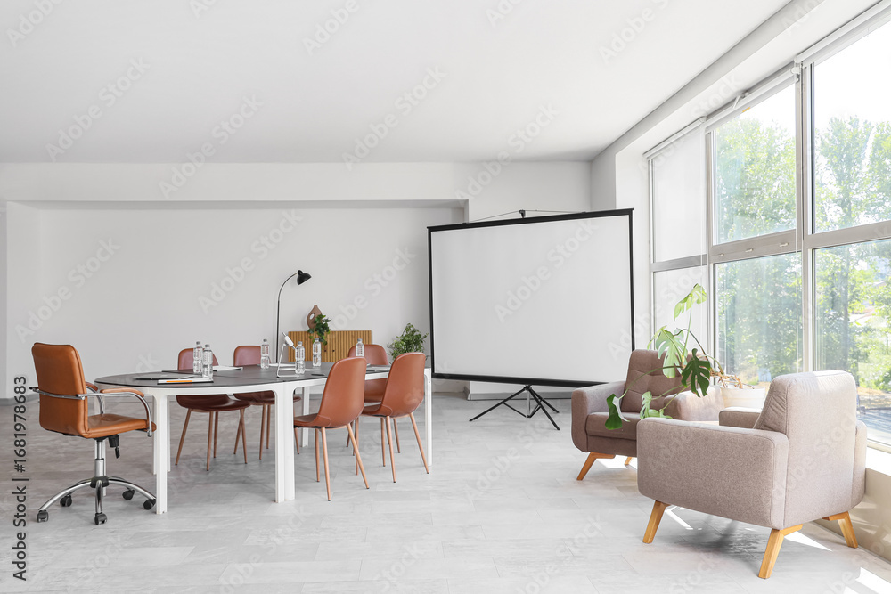 Fototapeta premium Interior of conference hall with desk, armchairs and projector screen