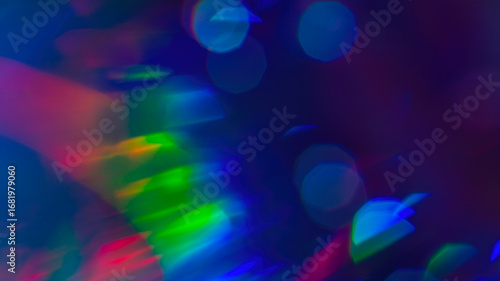 Abstract rainbow bokeh lights, colorful holographic blur on dark background, vibrant glowing texture