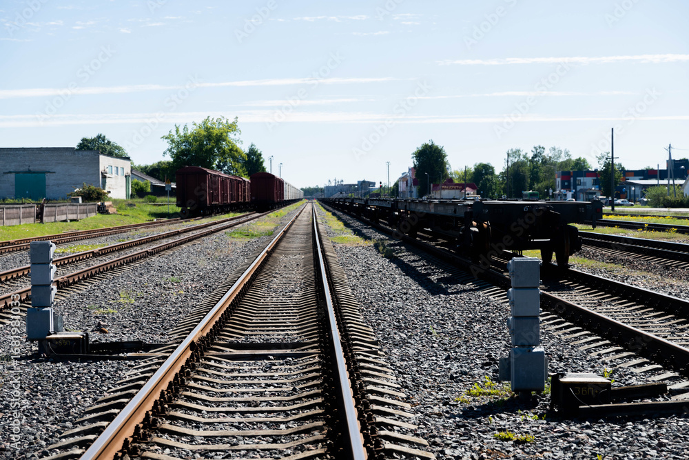 Fototapeta premium Shiny metal railway tracks stretching far into the distance