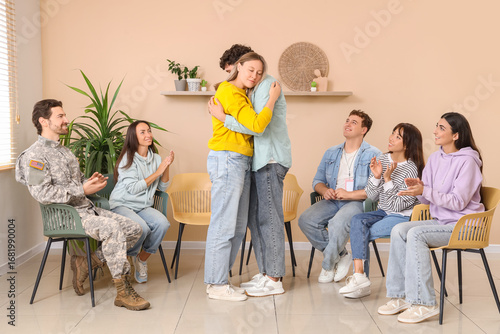 Young people hugging at gro...