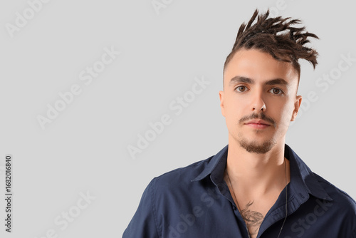 Young man with dreadlocks o...