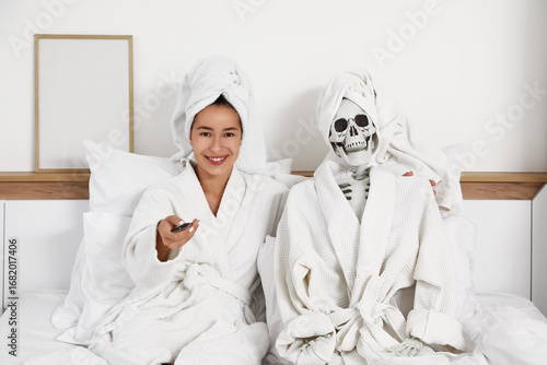 Young woman and human skele...