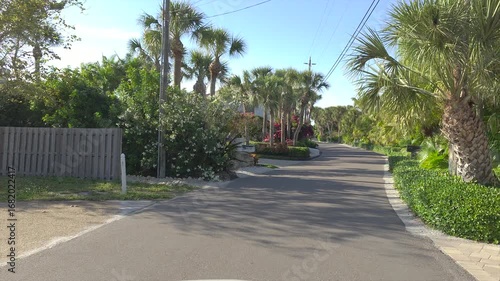 Wallpaper Mural Driving on Florida scenic road. Car point of view of Casey Key coastal neighborhood with tropical nature and southern architecture Torontodigital.ca