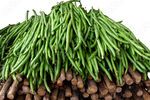 Fresh green beans piled high on wooden supports