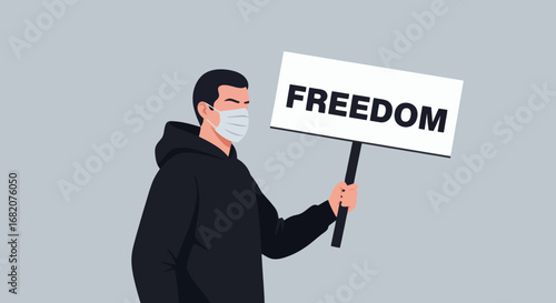 Person in black hoodie and white face mask holds a FREEDOM sign on a plain grey background