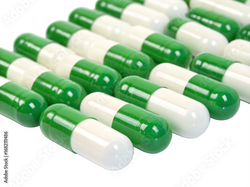 Green and white capsules in rows isolated on transparent background