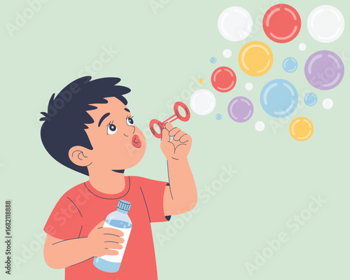 Joyful childhood moment of a little boy creating colorful soap bubbles against a plain background