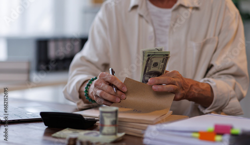 Fotografía Asian male accountant or banker making money calculations