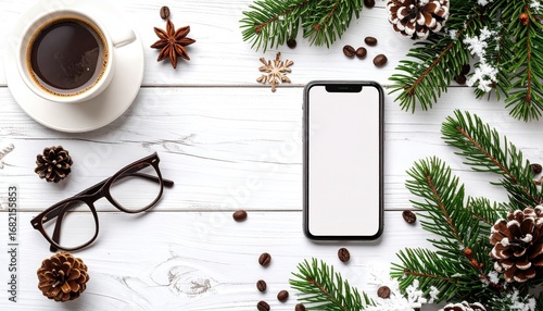 Holiday workspace phone surrounded by pine needles, coffee, cones, star anise, & glasses atop a white wooden surface. Bright, inviting, & seasonal