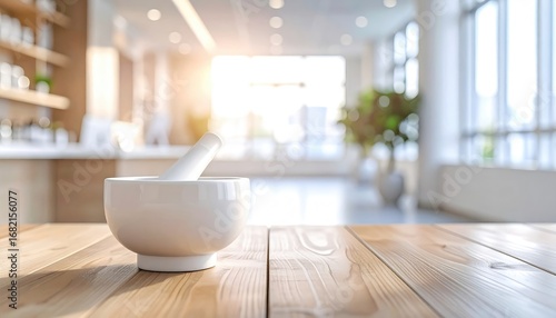 An elegant, sun-drenched interior showcases a white mortar and pestle on a wooden table. Blurry background reveals light wood shelves and a potted plant