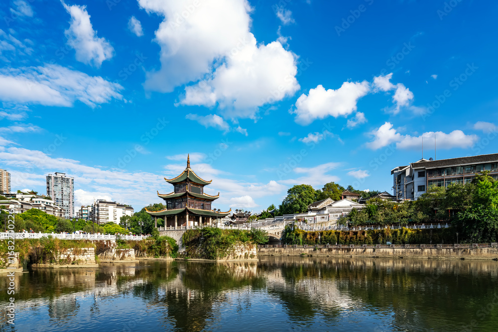 Fototapeta premium Traditional Chinese pavilion by the calm lake under a clear blue sky