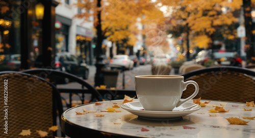 Autumn Coffee Shop Scene Hot Drink on Outdoor Table with Fall Leaves and Blurred City Background