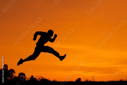 Wallpaper Mural Silhouette of a man leaping against an orange sunset sky Torontodigital.ca