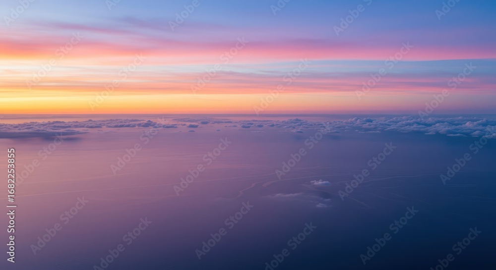 Fototapeta premium A breathtaking aerial view of a pastel sunrise over a vast expanse of clouds, showcasing soft, blended colors and a serene atmosphere.