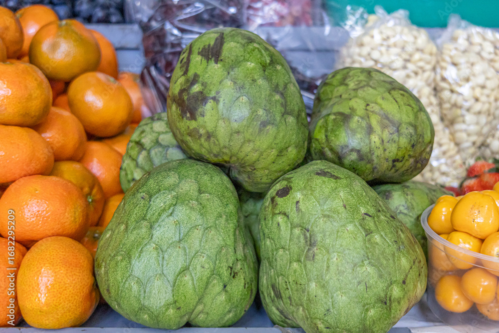 Obraz premium Fresh cherimoyas from Ecuador, an Andean fruit with creamy pulp and unique tropical flavor. A natural treasure that evokes health, biodiversity, and agricultural richness. 