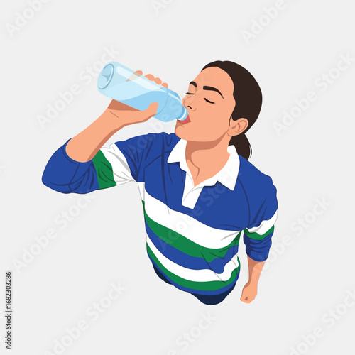 Person in rugby shirt drinking water from a plastic bottle.