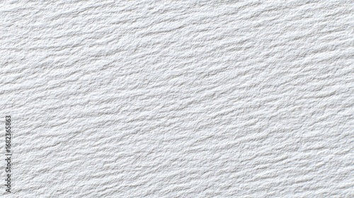 A close-up view of a textured white surface with subtle ridges and grooves, showcasing a smooth, even tone across the entire image.