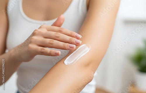 Woman applying lotion to arm