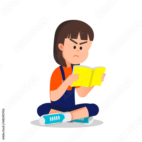 A little girl sits on the floor reading a book with a very serious expression