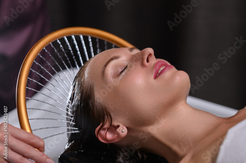 Obraz na płótnie Relaxing Japanese head spa with golden water arc
