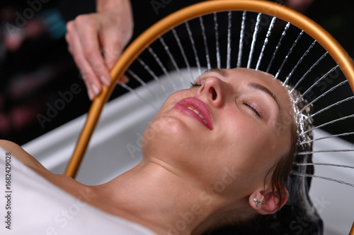 Relaxing head spa with golden water arc