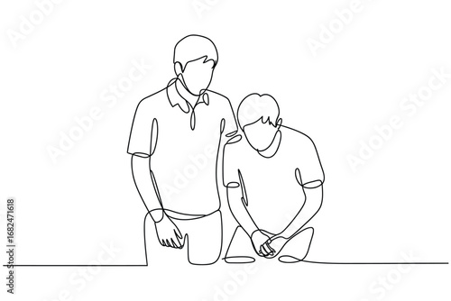 Two people standing together with one comforting the other