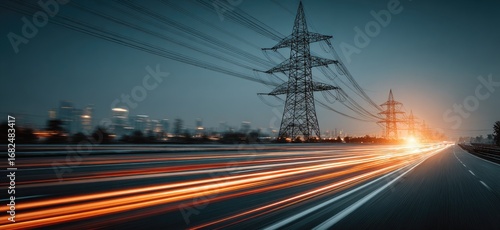 Night highway with blurred car lights, city lights, and power pylons