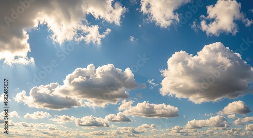 Sunlight filtering through cumulus clouds on a blue sky