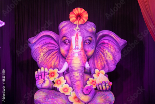 Photography Ganesh idol with floral decoration, Vibrant Ganesha statue with flowers, Lord Ganesha with mouse and sweets, Artistic Ganesh murti for festival stock photos