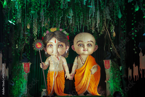 Photography Child Ganesh and friend idol, Cute Ganpati with companion statue, Artistic baby Ganesha murti, Decorative spiritual kid idols Stock Photo