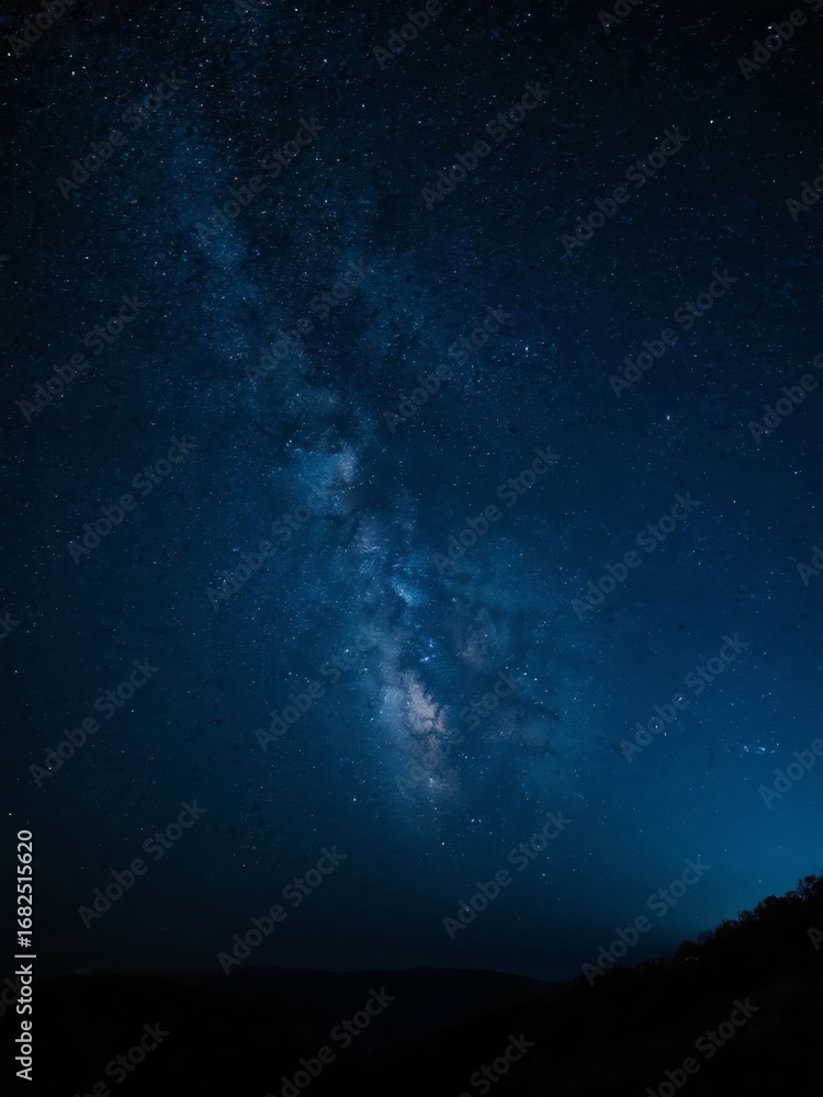 Fototapeta premium Starry Night Sky with the Milky Way Galaxy Over Silhouetted Hills