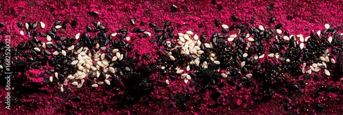 Crimson powder ground with mixed seeds in a row, close-up macro