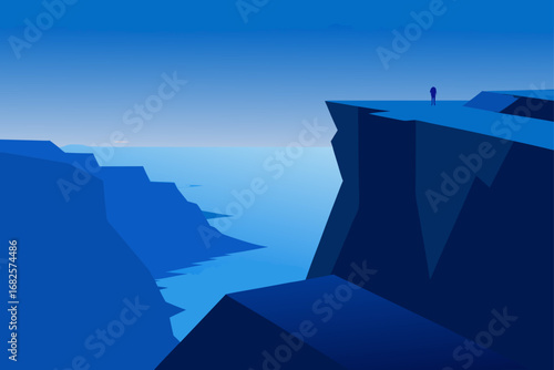 Lone figure standing on a cliff edge overlooking a vast blue ocean and canyon landscape