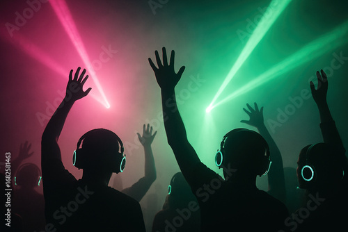 Silent Disco Crowd Silhouettes Dancing Under Pink and Green Stage Lights.