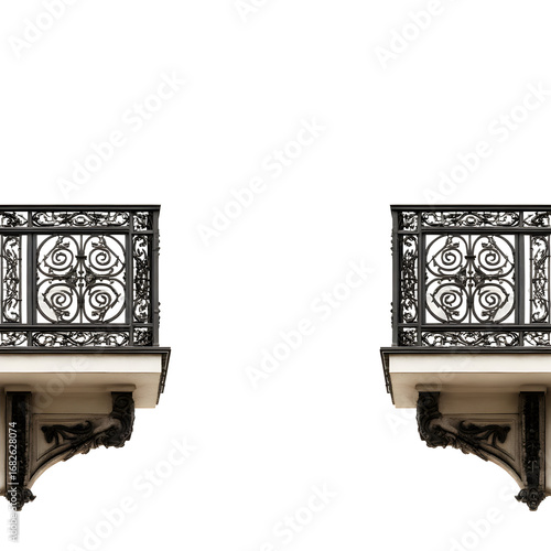 Symmetrical ornate iron balconies isolated against a black backdrop creates contrast
