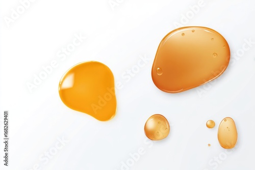Amber liquid spills on white background