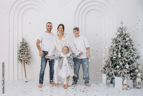 Family father, mother, son and daughter celebrate Christmas together, happy, stylish