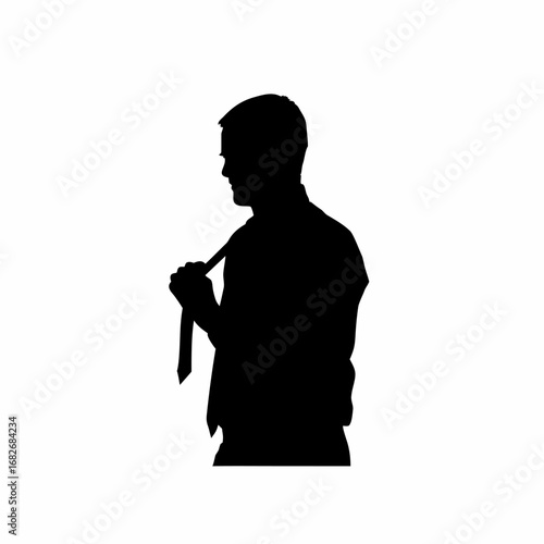Man tying necktie in silhouette preparing for office work
