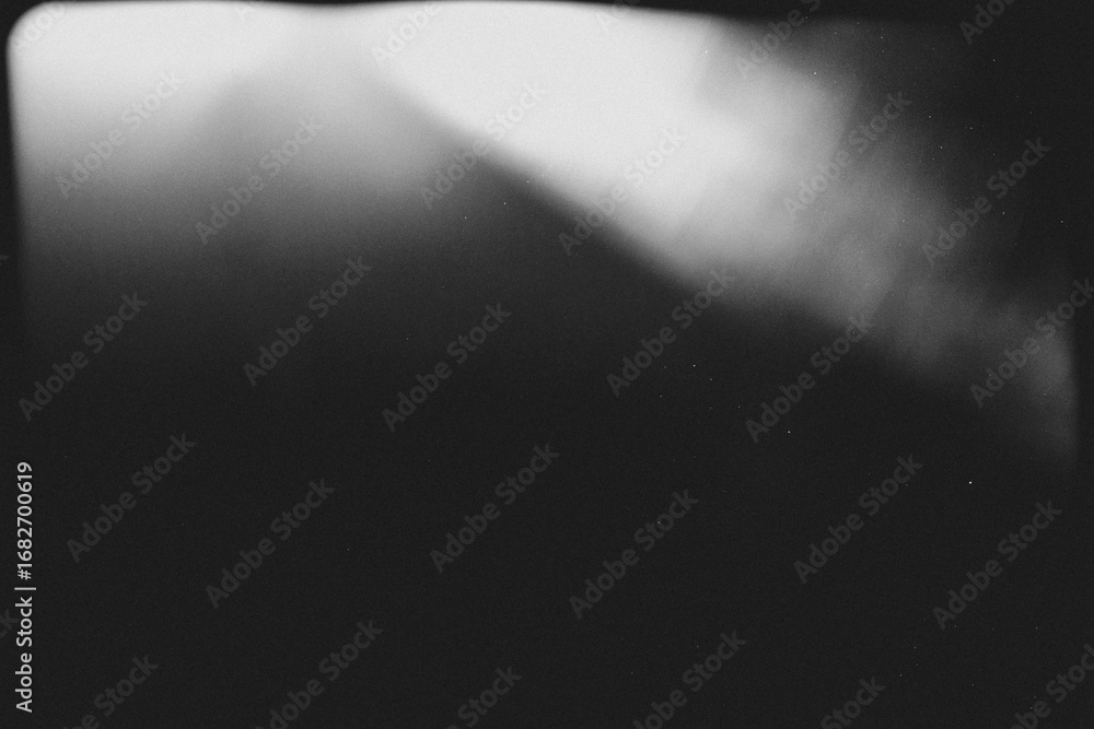 Obraz premium light leak overlay effect with scratch dust and ray light leaks,retro noisy film texture light leak flare on black background,black and white background,grunge film background