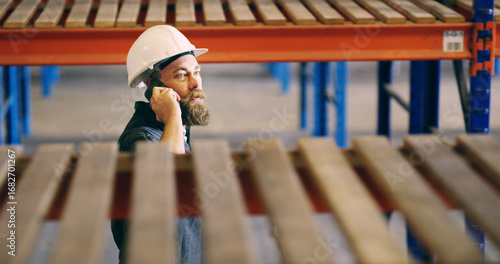 Man, logistics and worker with phone call in warehouse for inventory shortage, supply chain or inquiry. Above, inspector and speaking to supplier for delivery schedule, shipping delay and inspection