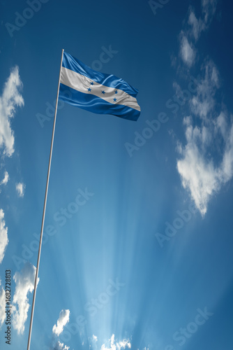 Waving National flag of Honduras on flagpole in sky