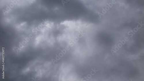 Dark storm clouds fill the sky, creating a moody atmosphere. The clouds are thick and gray, indicating an impending storm.