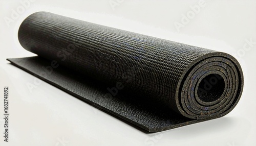 Rolled up black yoga mat, ready for use, resting on a plain surface.