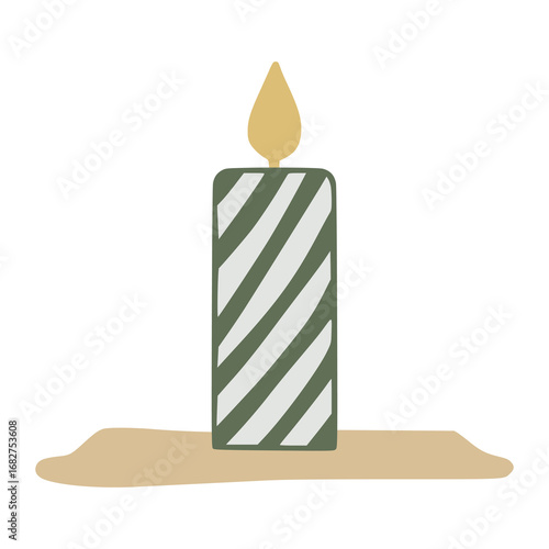 Green striped christmas candle burning on a beige surface